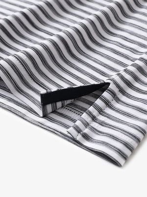 Close-up of hem slit detail on BLACK WHITE Unique Watercolour Stripe Polo