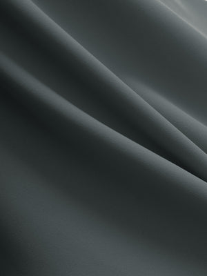 Close-up texture of dark grey flat front golf joggers pants with belt loops fabric showing detailed material and weave.