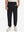 Model wearing black fleece stretch water resistant boys joggers, front view showing lower body and pants.