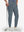 Front lower body shot of model wearing grey blue flat front golf joggers pants with belt loops