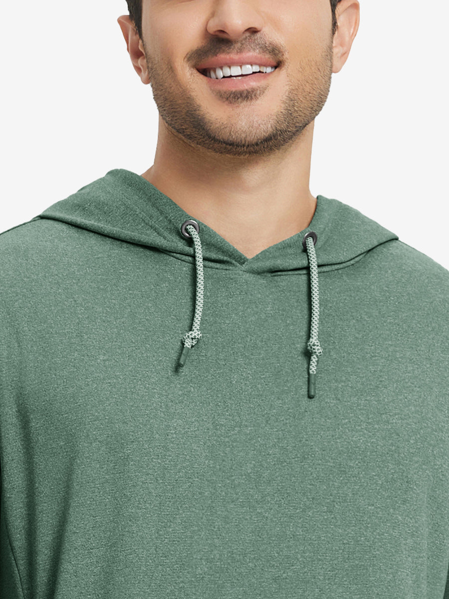Close-up from nose to chest, showing soft heather texture and collar detail of the dark green melange hoodie.