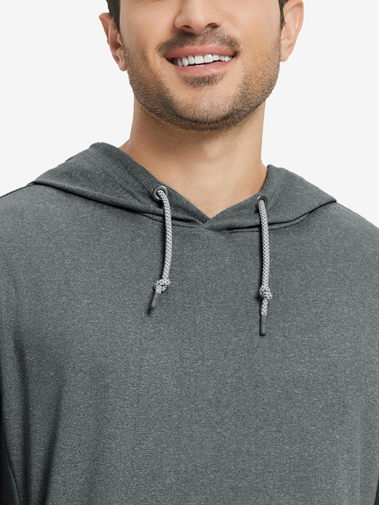 Close-up from nose to chest, showing soft heather texture and collar detail of the black melange hoodie.