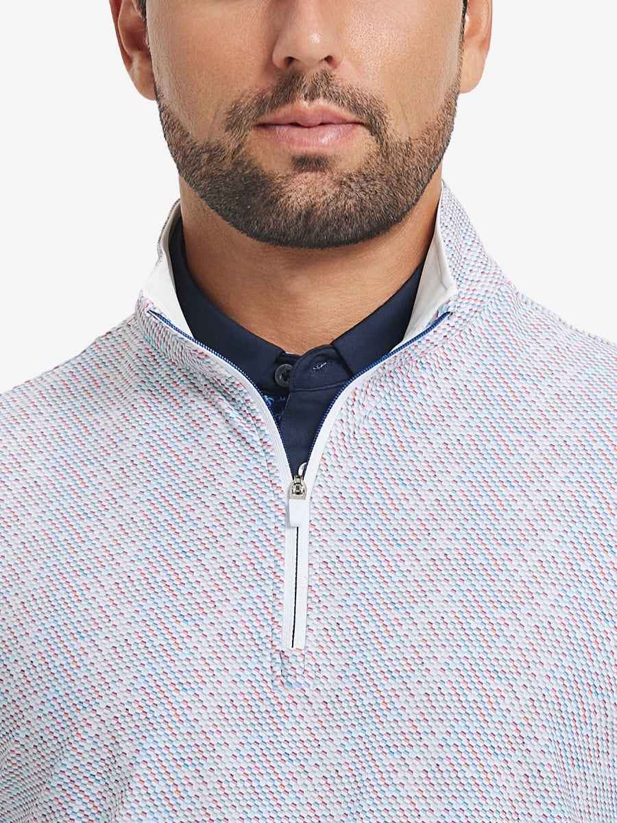 Close-up from nose to chest, showing zipper collar detail and fabric pattern of the colorful hexagon pullover.