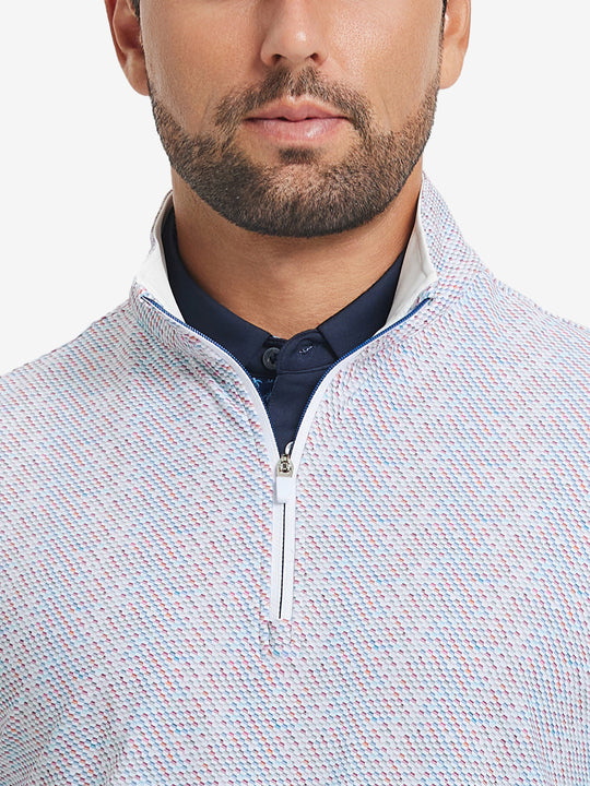 Close-up from nose to chest, showing zipper collar detail and fabric pattern of the colorful hexagon pullover.