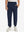 Model wearing navy fleece stretch water resistant boys joggers, front view showing lower body and pants.