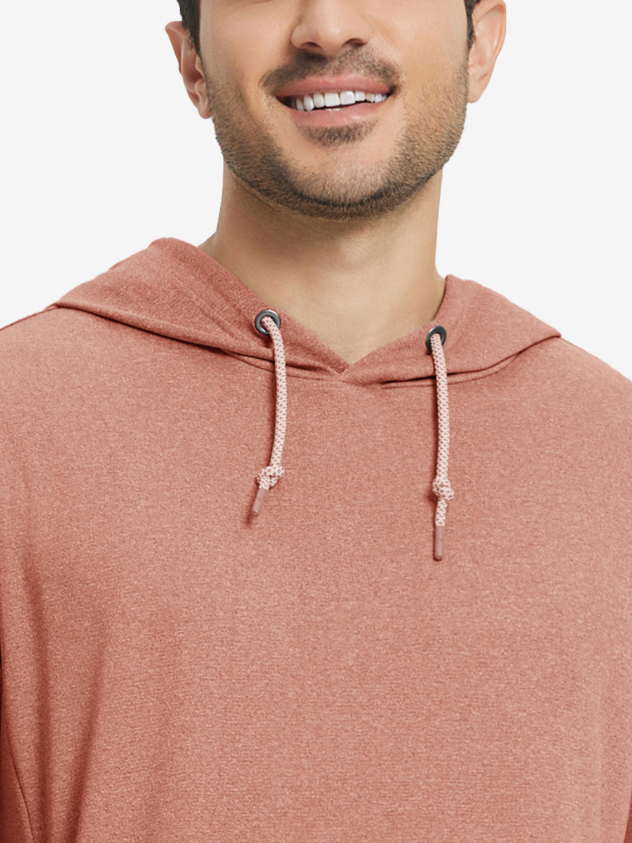 Close-up from nose to chest, showing soft heather texture and collar detail of the brick melange hoodie.