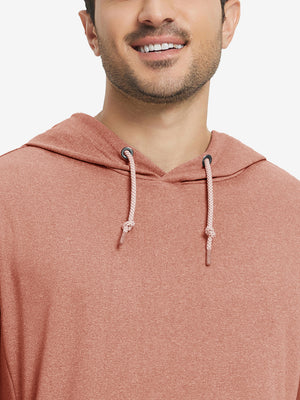 Close-up from nose to chest, showing soft heather texture and collar detail of the brick melange hoodie.