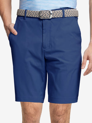 Front waist to knee view of cobalt water resistant golf 9 inch shorts, clean athletic fit.