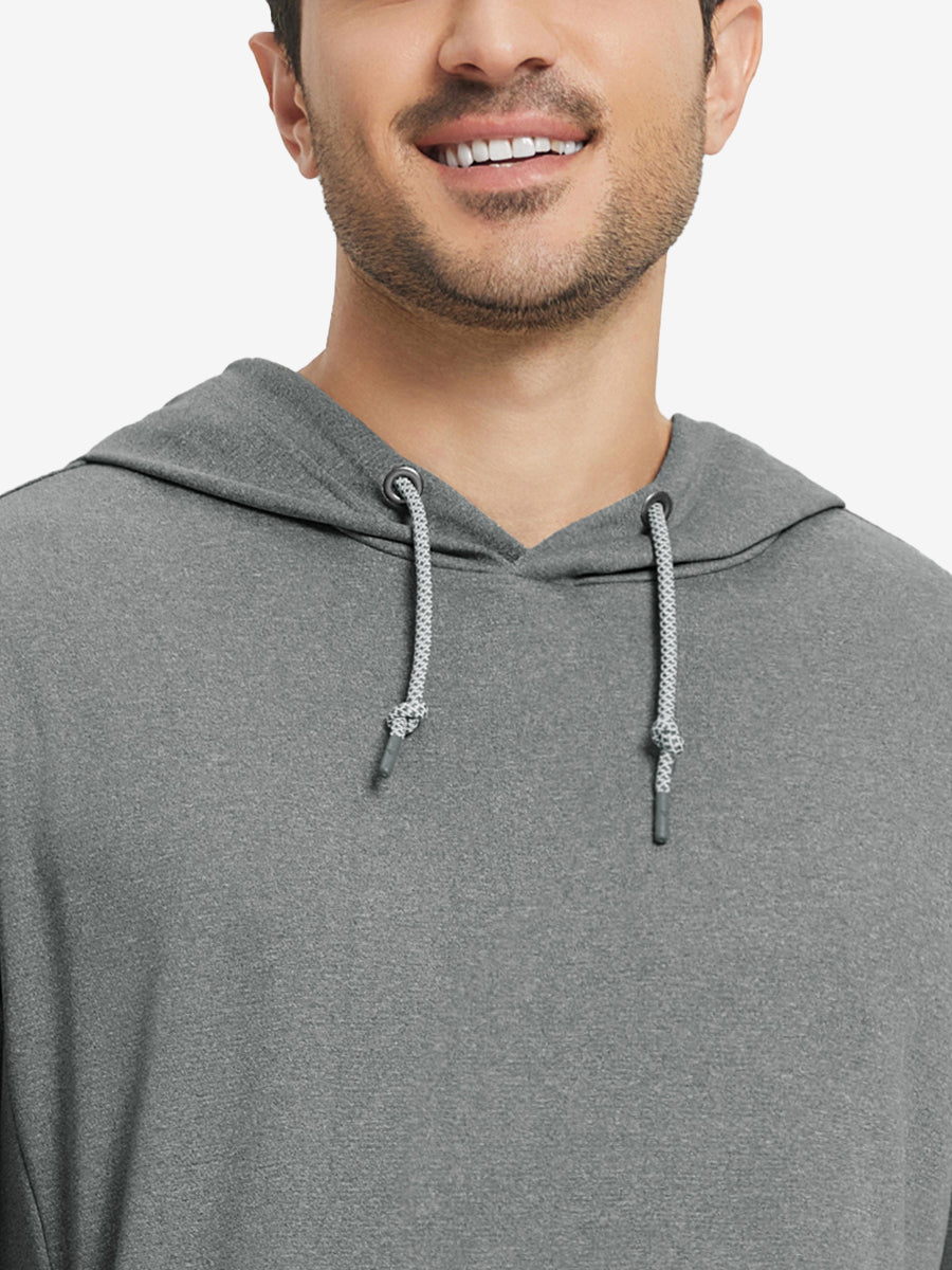 Close-up from nose to chest, showing soft heather texture and collar detail of the grey melange hoodie.