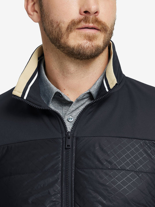 Close-up from nose to chest, showing collar detail and fleece texture of the black winter jacket.