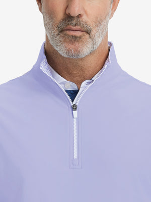 Close-up from nose to chest, showing collar detail and zipper of the lavender golf vest.