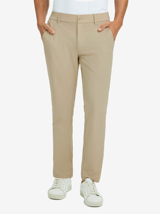 Front lower body view of model with hand in pocket, wearing quick dry casual dress pants in khaki.
