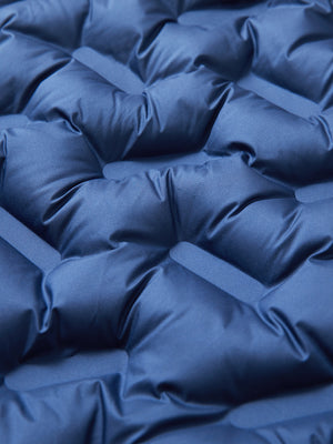 Fabric close-up showing the material of dark blue boys full-zip fleece-lined puffer vest.
