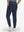 Back lower body shot of model wearing navy flat front golf joggers pants with belt loops