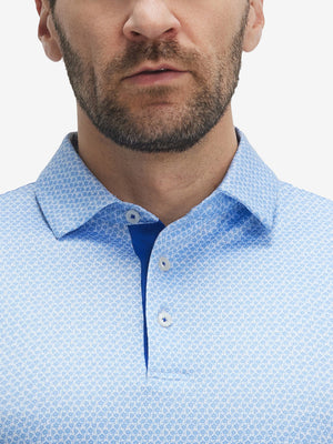 Front view from nose to chest of model wearing sky blue flower performance quick dry print golf polos