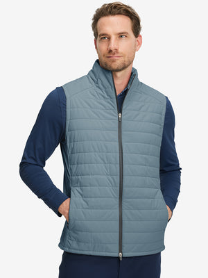 Model wearing Lightweight Water Resistant Puffer Vest in slate blue, upper body front view