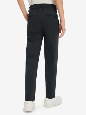 Boys Stretch Fleece Lined Casual Golf Pants in black, back lower body view showing fit