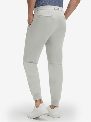 Front lower body shot of model wearing silver gray flat front golf joggers pants with belt loops