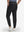 Back lower body shot of model wearing black flat front golf joggers pants with belt loops