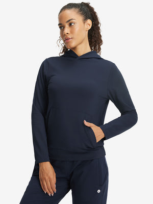 Model with one hand in side pocket wearing women's lightweight hoodies pullover in navy.