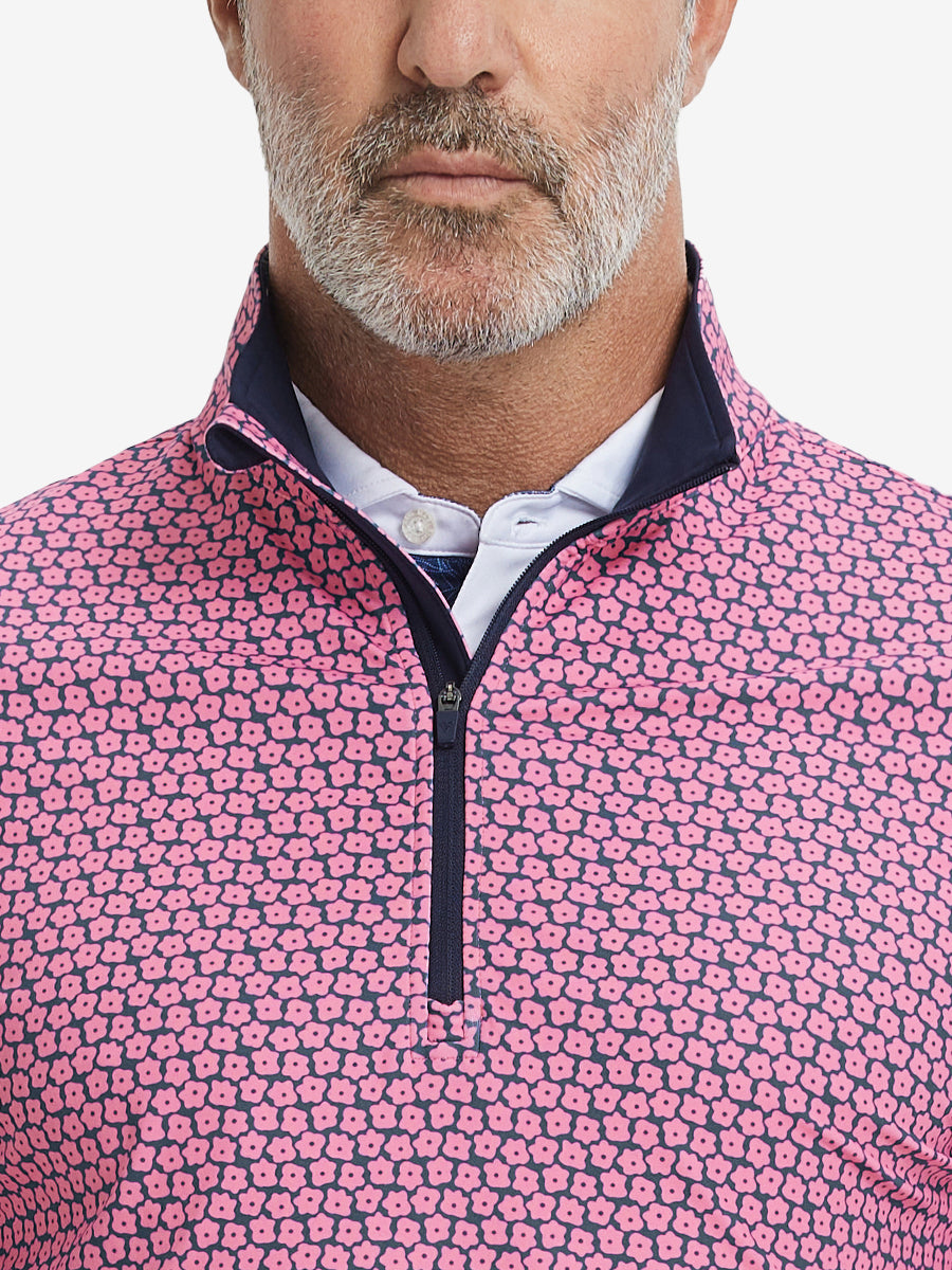 Close-up from nose to chest, showing zipper collar detail and fabric pattern of the red navy flower pullover.