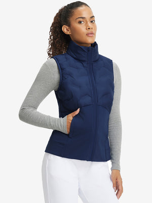 Front upper body of model wearing women's lightweight slim-fit puffer vest, sleek fit in navy