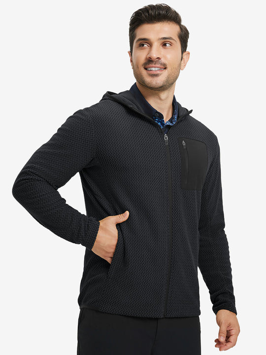 Model with one hand in pocket wearing full zip fleece hoodied jacket in black, relaxed look.
