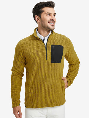 Model with one hand in side pocket, wearing midweight warm stretchy quarter zip pullover in yellow.