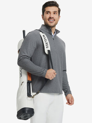Model carrying golf bag in Premium jacquard quarter zip pullover with versatile grey