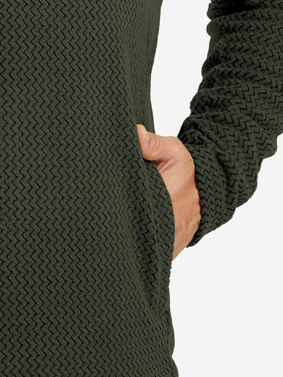Close-up of pocket detail on midweight warm stretchy quarter zip pullover in forest green, showing neat stitching.