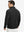 Back upper view of model in midweight warm stretchy quarter zip pullover, highlighting shoulder fit in black.