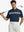 Half-body front view of model holding golf club wearing NAVY Stylish Chest Print Snap Polo