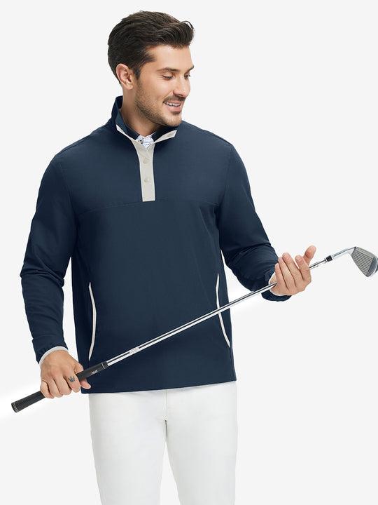 Model holding golf club, wearing mock neck quarter button golf pullover in navy, sporty look.