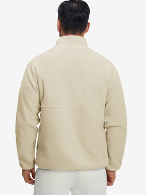 Back view of the model in the reversible fleece jacket with 5 pockets in khaki.