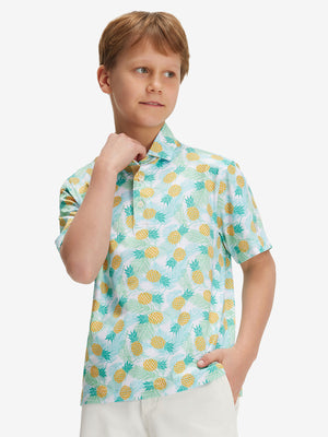 Front half-body of boy in leaves pineapple performance print boys golf polo