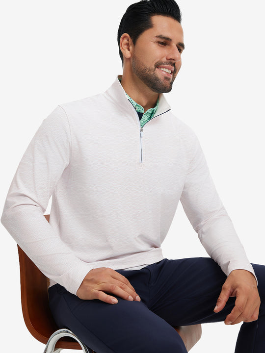 Model seated on chair, wearing full print quarter zip pullover in orange line, casual upper body view.