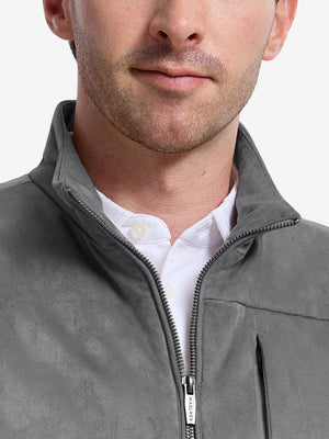 Front view from nose to chest of model wearing neutral grey  classic micro suede leather puffer vest
