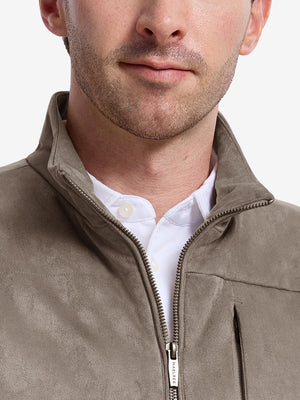 Front view from nose to chest of model wearing gray brown  classic micro suede leather puffer vest