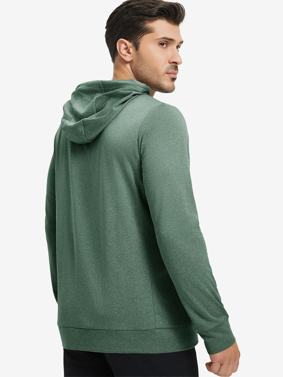 Back upper body view of the dark green melange classic heather hoodie, model turns head slightly with ease.