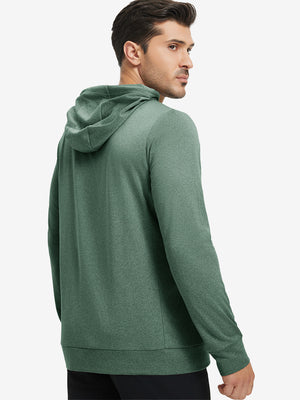 Back upper body view of the dark green melange classic heather hoodie, model turns head slightly with ease.