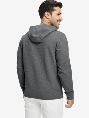 Back view of model wearing texture solid hoodies pullover showing fit and hood detail, grey heather.