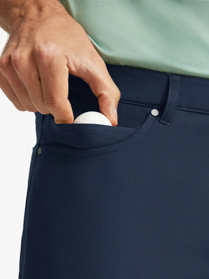 NAVY 4-way Stretch Performance Solid Shorts, front pocket holding golf ball detail, 7 Inch