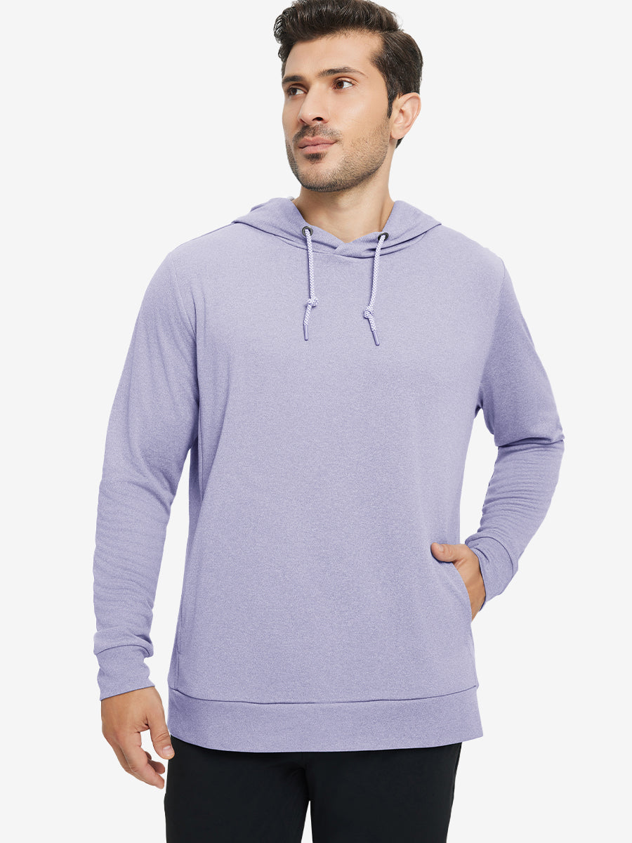 Model with one hand in pocket, wearing classic heather pullover hoodie in light purple melange, relaxed look.