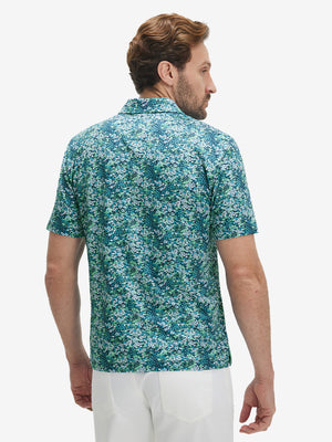 Back upper body view of model in Performance quick dry print golf polos with subtle navy green floral tone