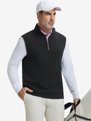 Model carrying golf bag, styled in black print collar quarter zip golf vest, relaxed sporty fit.