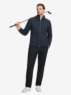Front full body shot of model wearing navy warm puffer winter golf jacket with golf club resting on shoulder