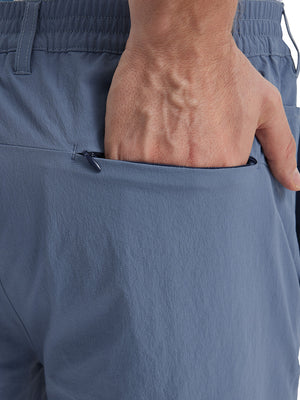 Back view of Performance Water Resistant Pants in DUSTY BLUE，model’s hand casually in back pocket.