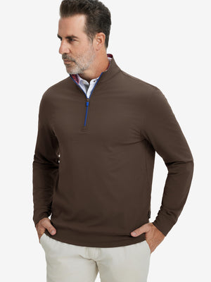 Front upper body view of model wearing lightweight golf quarter zip pullover in coffee brown, relaxed fit.