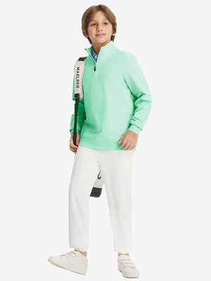 Full body model carrying a golf bag, wearing youth winter micro-fleece quarter zip pullover in turquoise