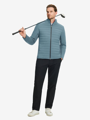 Front full body shot of model wearing slate blue warm puffer winter golf jacket with golf club resting on shoulder